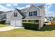 Two-story house with gray siding, two-car garage, and manicured lawn at 5908 Bluegrass Vw, Fairburn, GA 30213