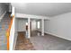 Open living room with tile and carpet flooring, and a view of the kitchen at 5908 Bluegrass Vw, Fairburn, GA 30213