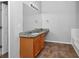 Bathroom with granite countertop, tiled floor, and a large mirror at 5908 Bluegrass Vw, Fairburn, GA 30213