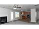 Open living room with fireplace and kitchen view at 5908 Bluegrass Vw, Fairburn, GA 30213