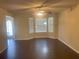 Living room with bay window, dark hardwood floors, and ceiling fan at 3897 Micah Ln, Ellenwood, GA 30294