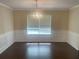 Formal dining room with chandelier, hardwood floors and wainscoting at 3897 Micah Ln, Ellenwood, GA 30294