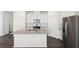 Modern kitchen with granite island, stainless steel appliances, and white cabinets at 269 Bald Ave # 18, Stockbridge, GA 30253