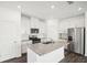 Modern kitchen with granite island, stainless steel appliances, and white cabinets at 269 Bald Ave # 18, Stockbridge, GA 30253