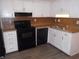 Clean, modern kitchen with white cabinets and black appliances at 1038 Ascot Ct, Riverdale, GA 30296