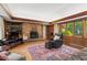 Spacious living room featuring a brick fireplace and hardwood floors at 4872 Northland Dr, Atlanta, GA 30342