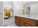 Bathroom with wood vanity, tiled floor, and view of bedroom at 3651 Chandler Haulk Rd, Loganville, GA 30052