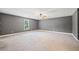 Large bedroom with ceiling fan and neutral colored carpet at 3651 Chandler Haulk Rd, Loganville, GA 30052