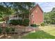 Brick house with a wraparound porch and landscaped yard at 3651 Chandler Haulk Rd, Loganville, GA 30052