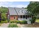 Brick home with a wrap around porch and landscaping at 3651 Chandler Haulk Rd, Loganville, GA 30052