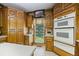 Spacious kitchen with ample wood cabinetry, double oven, and a view from the window at 3651 Chandler Haulk Rd, Loganville, GA 30052