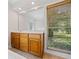 Bathroom with vanity, window, and tiled flooring at 3651 Chandler Haulk Rd, Loganville, GA 30052