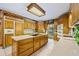 Kitchen boasts wood cabinets, granite counters and island at 3651 Chandler Haulk Rd, Loganville, GA 30052