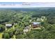 Aerial view showcasing a home nestled in a wooded area with Stone Mountain in the background at 3651 Chandler Haulk Rd, Loganville, GA 30052