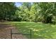 Open grassy yard with a wooden fence at 3651 Chandler Haulk Rd, Loganville, GA 30052