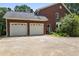 Two-car garage with driveway and landscaping at 3651 Chandler Haulk Rd, Loganville, GA 30052