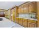 Kitchen features wood cabinets, granite countertops, and an island at 3651 Chandler Haulk Rd, Loganville, GA 30052