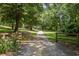 Long driveway leading to a wooded property at 3651 Chandler Haulk Rd, Loganville, GA 30052