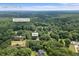 Aerial view of a home situated on a wooded lot near Little Haynes Creek at 3651 Chandler Haulk Rd, Loganville, GA 30052
