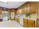 Kitchen with wood cabinets, tile countertops, and island at 3651 Chandler Haulk Rd, Loganville, GA 30052