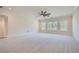 Large bedroom with carpeted floors, ceiling fan, and multiple windows at 4215 Tattnall Run, Acworth, GA 30101