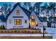 Luxury two-story home with stone accents and three-car garage at dusk at 4215 Tattnall Run, Acworth, GA 30101
