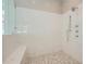 Spa-like shower with marble tile, built-in seat, and rainfall shower head at 4215 Tattnall Run, Acworth, GA 30101