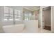 Luxurious bathroom with freestanding tub, walk-in shower, and marble flooring at 4215 Tattnall Run, Acworth, GA 30101