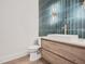 Modern bathroom with teal tile and floating vanity at 4215 Tattnall Run, Acworth, GA 30101
