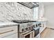 Luxury kitchen with stainless steel range and marble countertops at 4215 Tattnall Run, Acworth, GA 30101