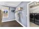 Convenient laundry room with washer, dryer, and ample storage shelving at 6435 Pond View Dr, Cumming, GA 30028