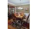 Formal dining room with hardwood floors, chandelier and china cabinet at 9904 Hamilton Dr, Douglasville, GA 30135