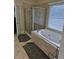 Bathroom with soaking tub and walk-in shower at 9904 Hamilton Dr, Douglasville, GA 30135