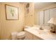 Small bathroom with yellow striped wallpaper and white vanity at 3081 Howell Mill Nw Rd # 3, Atlanta, GA 30327