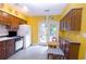 Kitchen features wood cabinets, access to backyard, and yellow walls at 3081 Howell Mill Nw Rd # 3, Atlanta, GA 30327