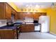 Galley kitchen with wood cabinets, stainless steel appliances, and yellow walls at 3081 Howell Mill Nw Rd # 3, Atlanta, GA 30327