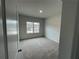 Bright bedroom with window and carpet flooring at 263 Arwen Drive Lot 65, Mcdonough, GA 30252
