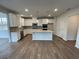 Modern kitchen with island, stainless steel appliances, and granite countertops at 263 Arwen Drive Lot 65, Mcdonough, GA 30252