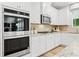 Modern kitchen with stainless steel appliances and granite countertops at 263 Arwen Drive Lot 65, Mcdonough, GA 30252