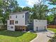 Modern two-story home with attached two-car garage and landscaped lawn at 1940 Fellowship Rd, Tucker, GA 30084