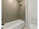 Bathroom with a bathtub and modern olive-green tile at 1940 Fellowship Rd, Tucker, GA 30084