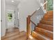 Modern staircase with wooden steps and black metal railing at 1940 Fellowship Rd, Tucker, GA 30084