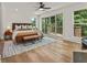 Main bedroom with hardwood floors, sliding glass doors to deck, and a ceiling fan at 1940 Fellowship Rd, Tucker, GA 30084
