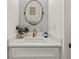 Small bathroom with white vanity, quartz countertop, and oval mirror at 1940 Fellowship Rd, Tucker, GA 30084