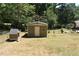 Small shed in the backyard with a dog house at 3400 Scott Dr, Austell, GA 30106