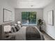Virtually staged bedroom with large window and treetop views at 2110 Glenwood Downs Dr, Decatur, GA 30035