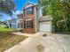 Brick front house with a white garage door and driveway at 2110 Glenwood Downs Dr, Decatur, GA 30035