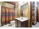 Basement bathroom with dark wood vanity and plaid shower curtain at 4567 Brigade Ne Ct, Roswell, GA 30075