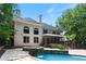 Two-story house with a screened porch, pool, and hot tub at 4567 Brigade Ne Ct, Roswell, GA 30075