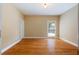 Simple bedroom with hardwood floors and a window at 4567 Brigade Ne Ct, Roswell, GA 30075